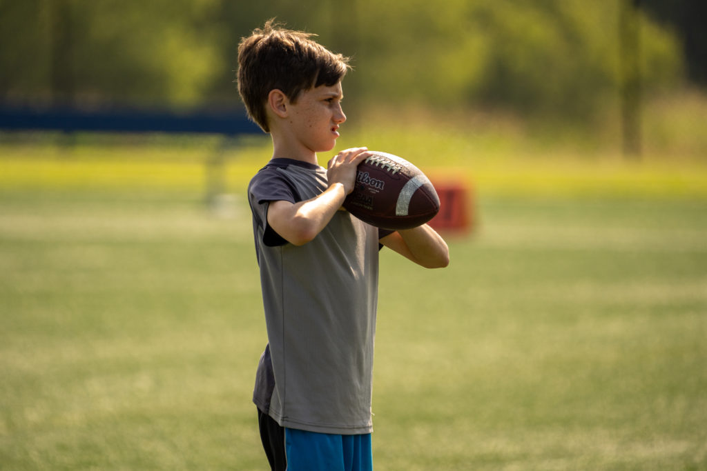child holding football