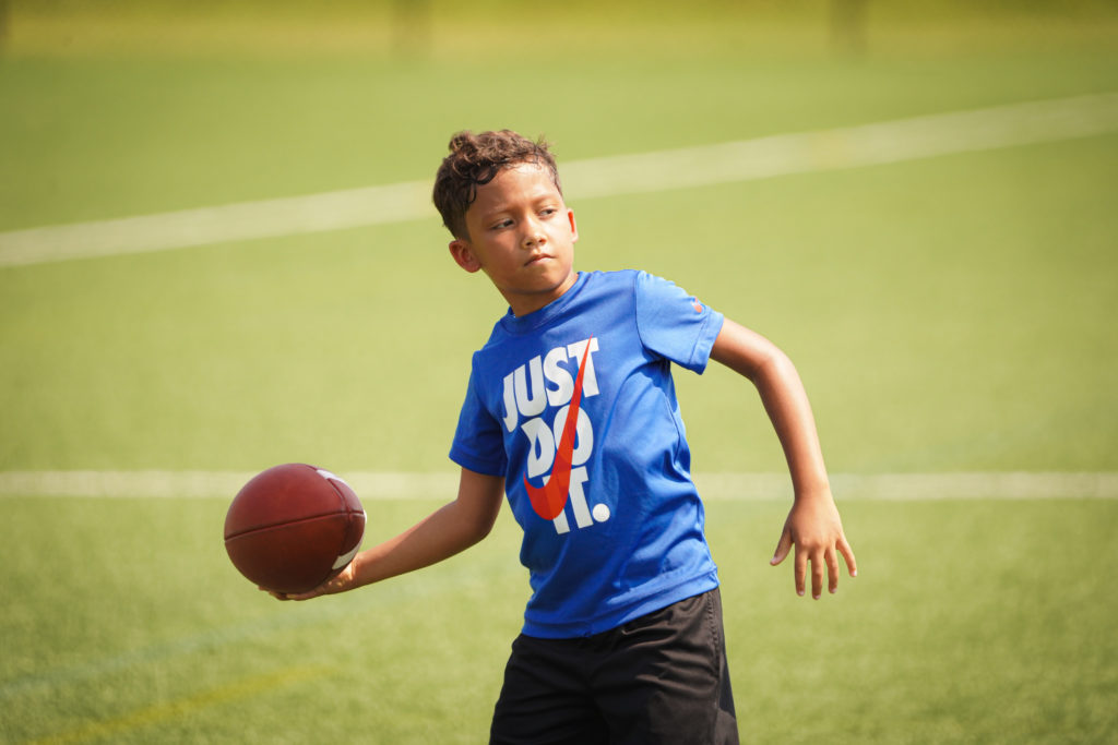 Boy throwing football