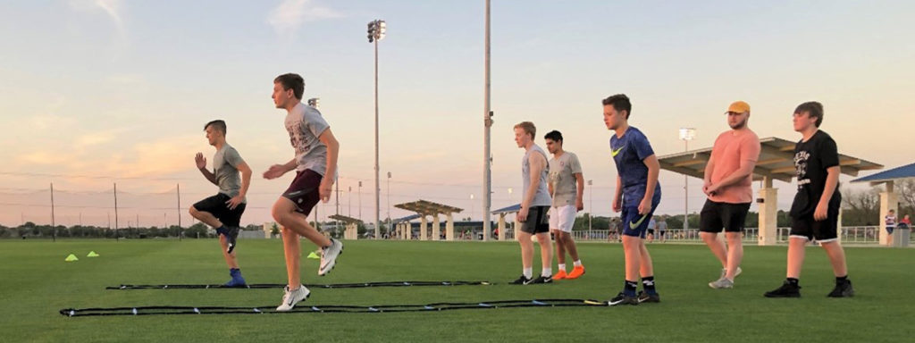 Teens on field running ladders