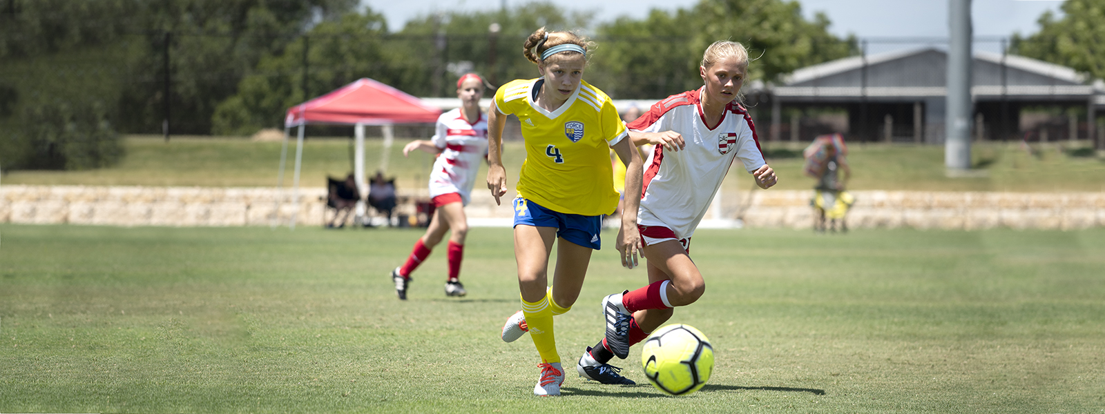 girls in socerr match kicking ball on field