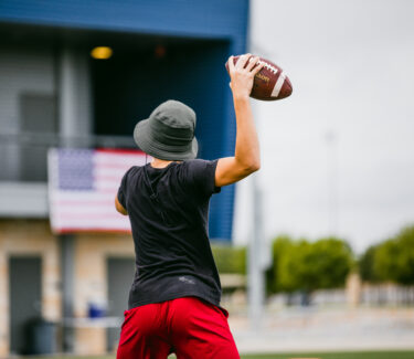 An athlete passing a football at the Round Rock Multipurpose Complex