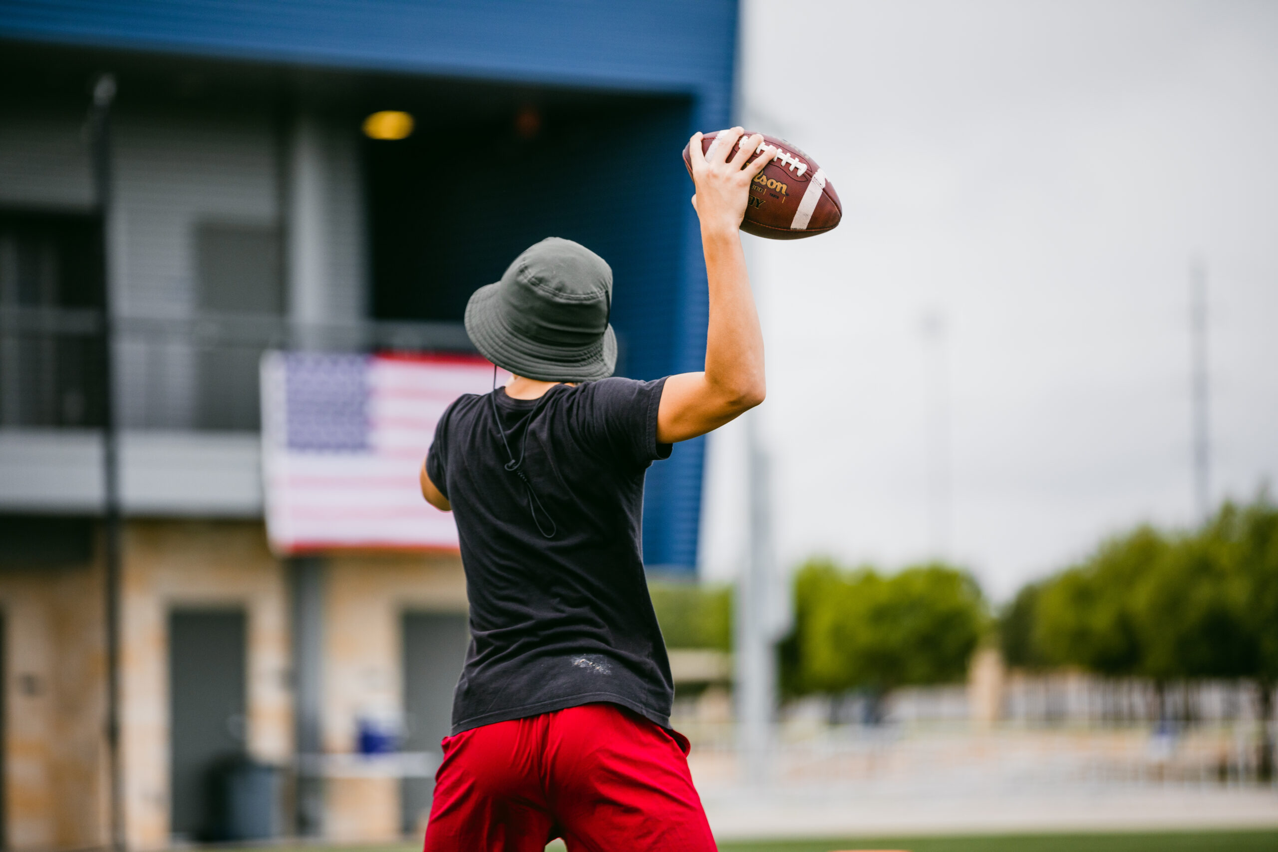 An athlete passing a football at the Round Rock Multipurpose Complex