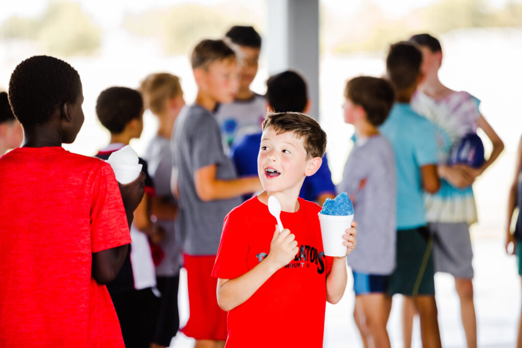 A camper enjoying a blue snow cone at the Round Rock Multipurpose Complex